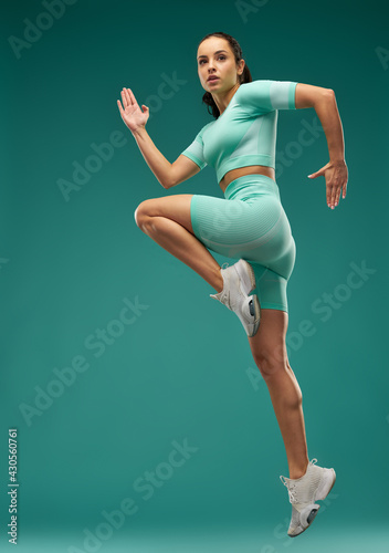 Sporty young woman jumping in the air
