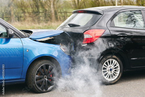 Two Damaged Cars Involved In Road Traffic Accident Showing Smoke After Collision