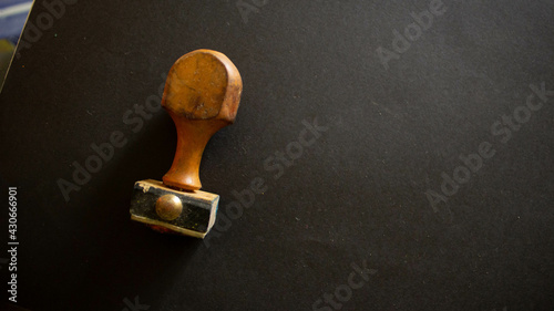 Closeup shot of a rubber stamper on a black surface