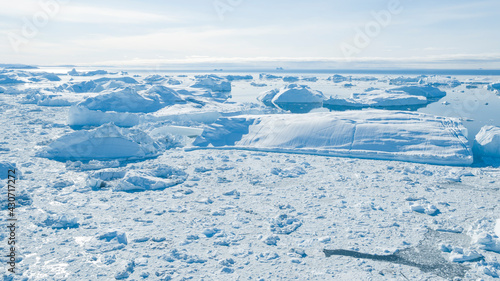 Climate Change. Iceberg afrom glacier in arctic nature landscape on Greenland. Icebergs in Ilulissat icefjord. Melting of glaciers and the Greenland ice sheet is a cause of sea levels rise