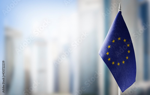 Small national flags of the European Union on a light blurry background