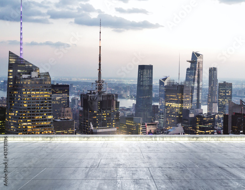 Empty dirty concrete rooftop on the background of a beautiful New York city skyline at twilight, mock up