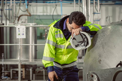 tired fatigue exhaustion engineer worker hard working in factory. worker sick from Corona virus flu.