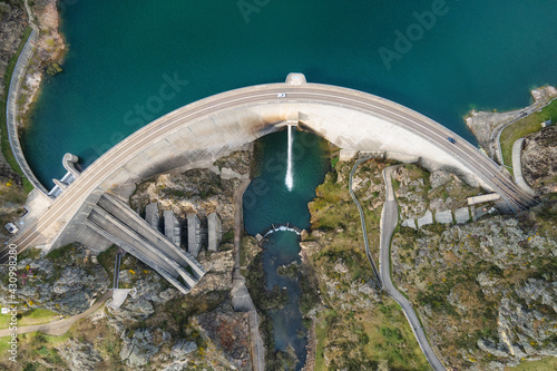 Aerial drone footage top view Water dam and reservoir lake, generating hydro electricity power renewable energy and sustainable development. High quality photo.