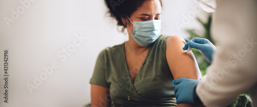 Woman receiving covid vaccination at home