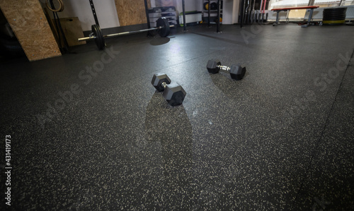 Wide angle dumbbells on the floor in the gym