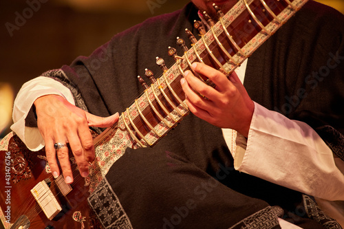 A man playing on an Indian Sitar, close-up