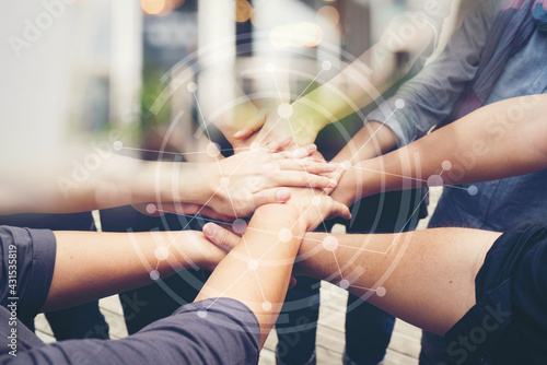 Close-up of the hands of people of different races, contracting trust and cooperation.