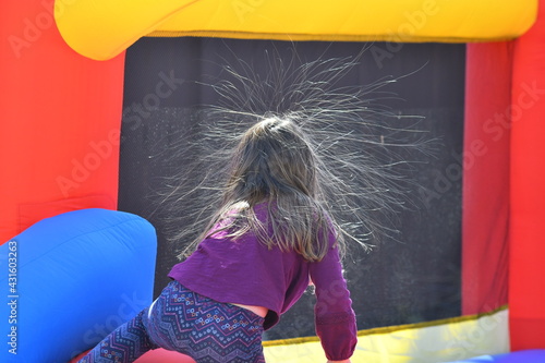 static hair sticking out from young girls head