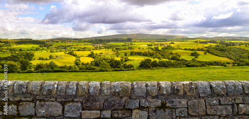 English countryside and farmland landscape panorama background along Hadrian's Wall Roman ruin. Beautiful rural country side pastures in England