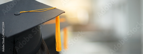 Young happy Asian woman university graduate in graduation gown and cap in the college campus. Education stock photo