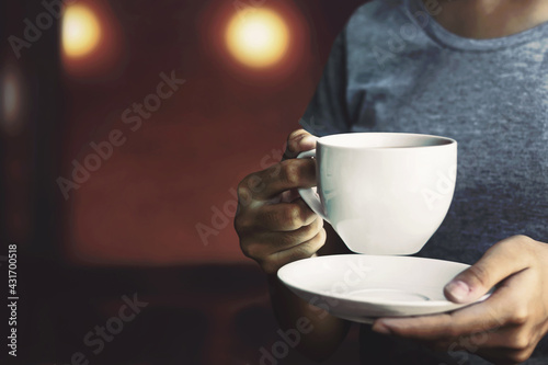 Girl holding a cup of hot coffee Having coffee in the morning