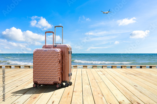 Travel suitcase on wood floor by the sea,travel concept.