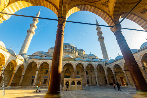 Picturesque architecture of north facade of ancient Suleymaniye Mosque with forecourt and central fountain in Istanbul on sunny day, Turkey..