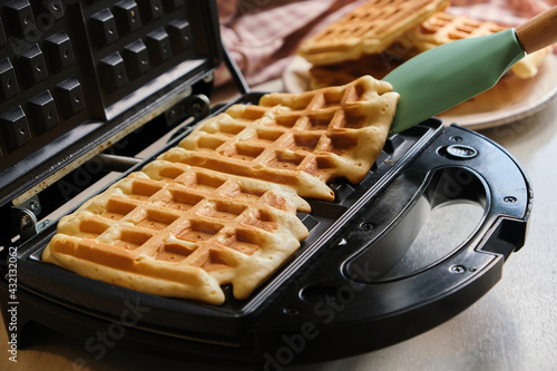 waffles are baked waffle iron machine. close up