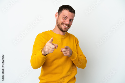 Young Brazilian man isolated on white background surprised and pointing front
