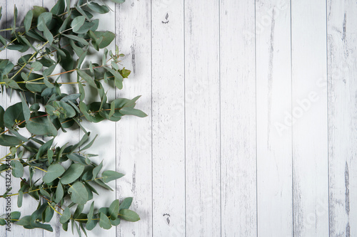 Decorated border background. On-trend farmhouse aesthetic flatlay flatlay on a white wood background. Negative copy space.