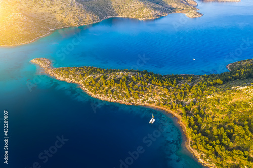 Aerial view of a catamaran yacht in the blue sea. Yachting, luxury vacation at sea.