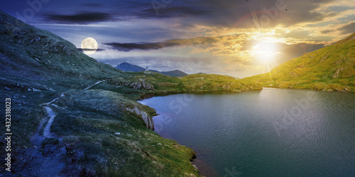 day and night time change concept above summer landscape with lake on high altitude. beautiful scenery of fagaras mountain ridge. open view in to the distant peak beneath a clouds with sun and moon