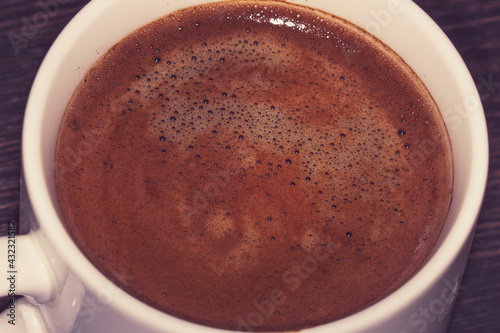 The texture of freshly brewed coffee close-up in a cup
