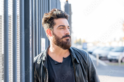 Portrait young man bearded posing outdoor serious