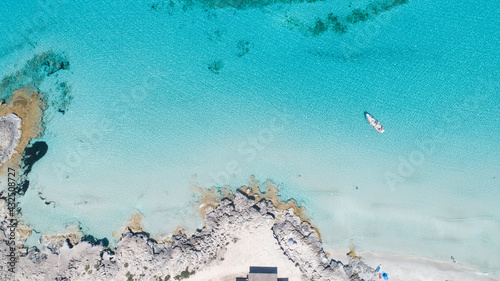 Sunny day on amazing beach with turquoise sea seen from a drone