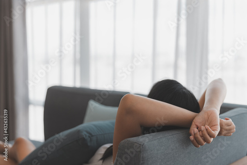 Asian woman relax and sleep on sofa at home