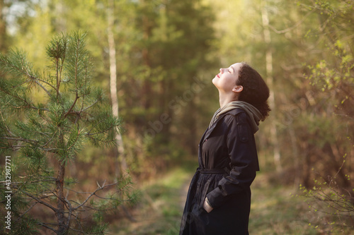 girl woman walking in nature park forest and breathing fresh air. concept of breathing, inhaling, relaxing