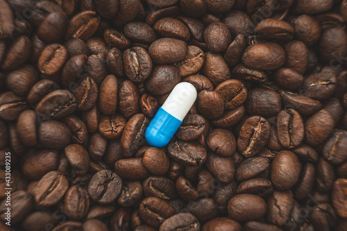 caffeine supplements. pill on the background of coffee beans.