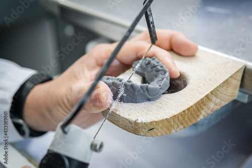 Dental technician manufacturing orthodontic dental prosthesis. Workplace of a dental technician