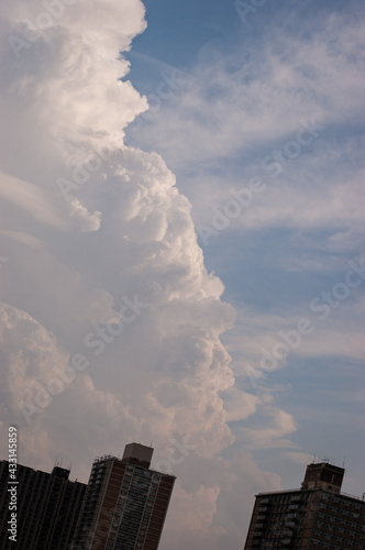 off kilter urban building silhouette with dramatic clouds