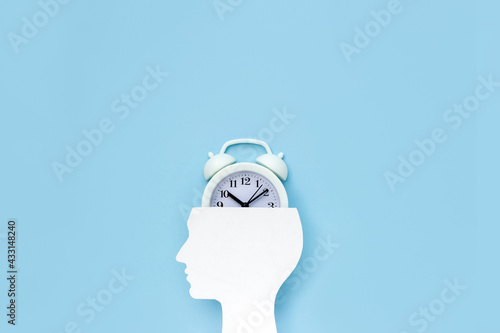 Human head with alarm clock. Concept of time management. Copy space. Selective focus