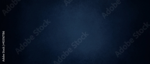 dark blue background texture with black vignette in old vintage textured border design, dark elegant teal color wall with light spotlight center