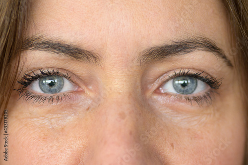 Close up on the grey blue eyes of a middle-aged woman