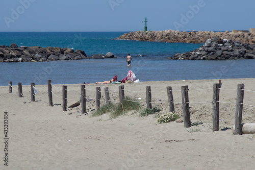 Seascape of sand beach in Italy. The lounge beach area with sandy and big stone . Overlooking the ocean and the seashore,Fiumicino,Italy.