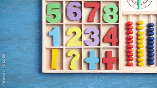 Colorful numbers on blue wooden table. Education. Learning
