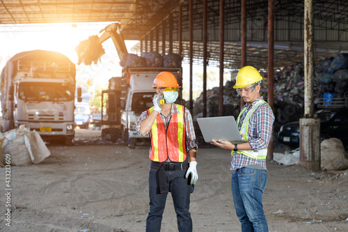 Portrait worker on recycle center,sanitation worker working in recycling plant Staff wearing reflective vests in an industrial interior