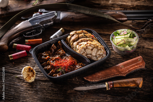 Savory and delicious deer venison goulash stew packed in portable take away plastic box. Food is served with homemade dumplings