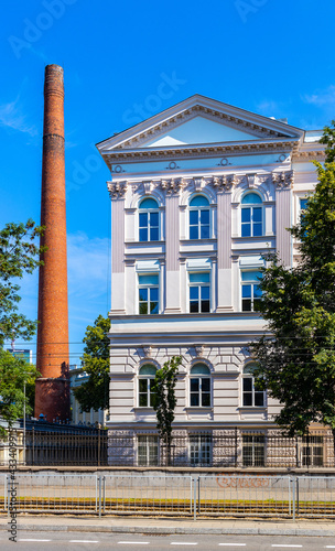 South wing of historic building of Warsaw Polytechnics technical university with vintage chimney in Srodmiescie city center district of Warsaw, Poland