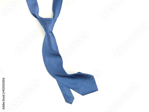 Father's day composition of blue tie laid isolated on a white background. Top view. Flat lay with space for text