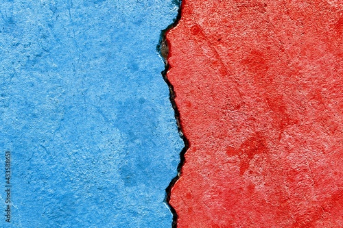 Abstract Bipartisan politics election conflicts concept, blue vs red colors on cracked wall background, e.g., US, UK or EU political parties disagreement competition relationship