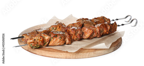 Metal skewers with delicious meat on white background