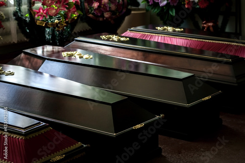 Coffins in a funeral home, selective focus. Funeral services.