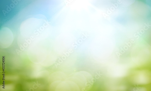 World environment day concept: green grass and blue sky abstract background with bokeh