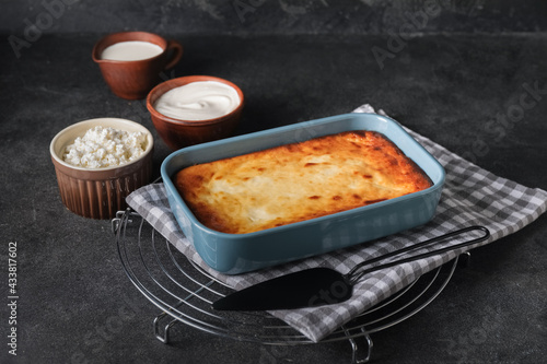 Dish with tasty cottage cheese casserole on table