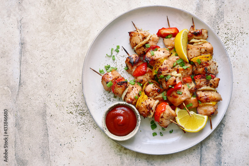 Chicken kebab skewers on a plate . Top view with copy space.