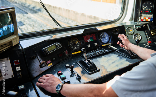 Interior view of the pilot hands and instrument panel cockpit of ancient train