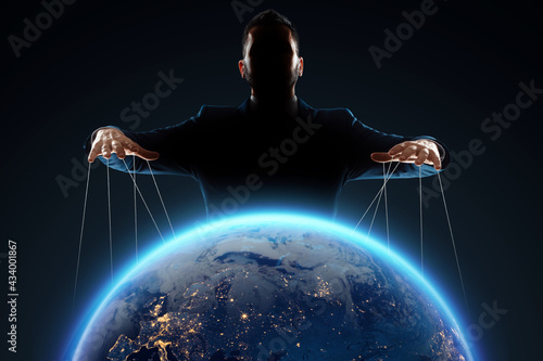 A man, a puppeteer, manipulates the planet. The concept of world conspiracy, world government, manipulation, world control.