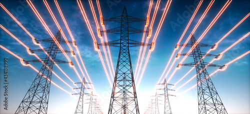 Electricity transmission towers with glowing wires against blue sky - Energy concept 