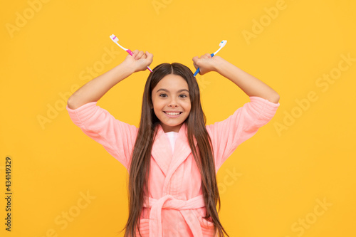 funny teen girl hold toothbrush. childhood happiness. morning routine.